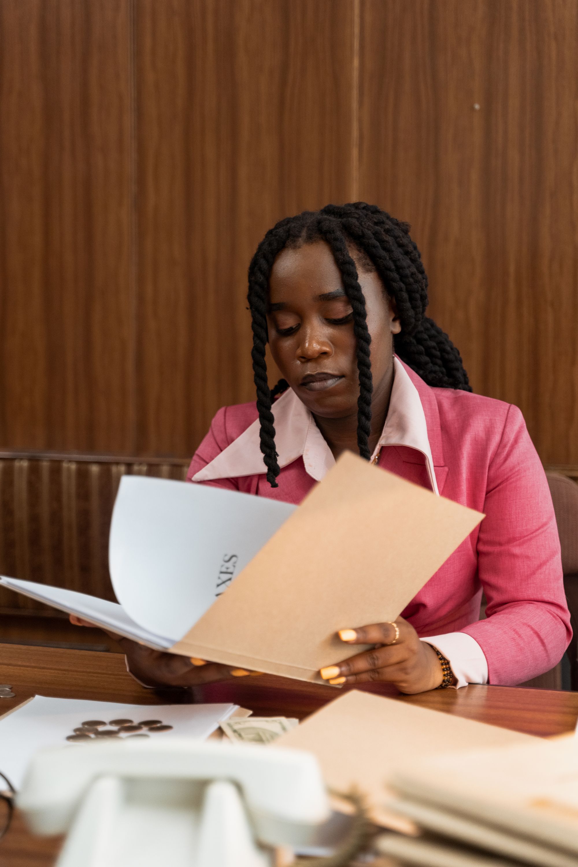 A professional reviewing business documents at her desk
