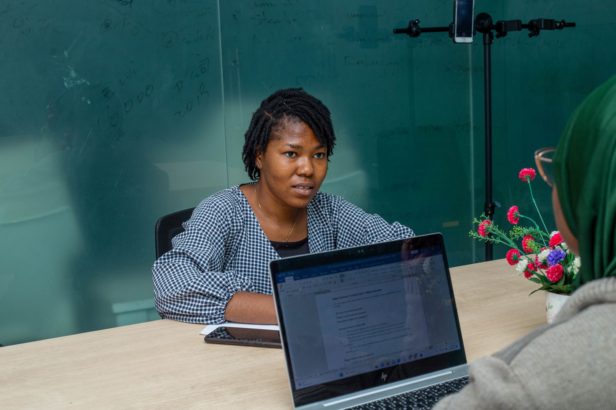 Business professionals discussing a project in a Lagos office